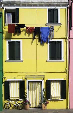 Bright yellow color house in Burano, Veniceの写真素材