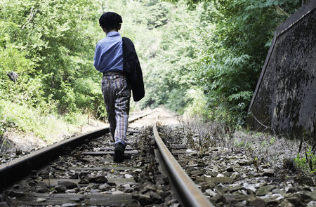 Child walking on railwayの写真素材