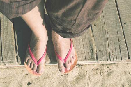Foot in thongs on the beach, Bulgariaの写真素材