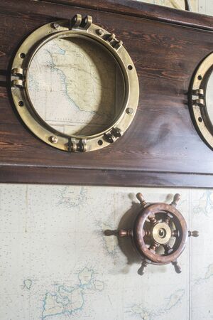 Boat details on wall. Vintage map and rudder. Greece