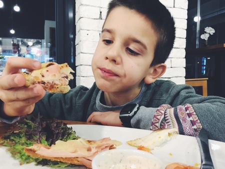 Child eat in fast food restaurant. Do not like the foodの素材