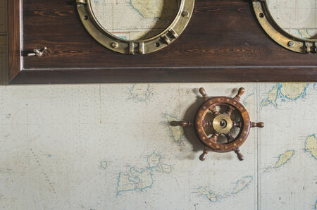 Boat details on wall. Vintage map and rudder. Greece
