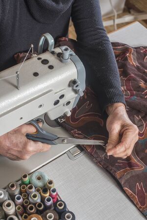 Woman sewing on a sewing machine.