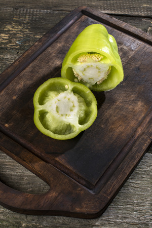 Cut green pepper on wood. Backlightの写真素材