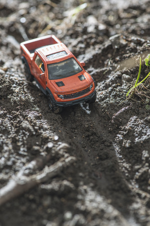 Small red off road car toy in the nature. Miniatureの写真素材