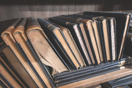 Old books in a vintage library shelvesの写真素材