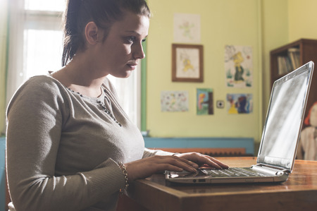 Student girl and laptop in a vintage libraryの写真素材
