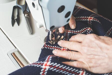 Woman sewing on a sewing machine. Close upの写真素材