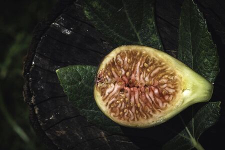 Figs and leaves on wood. Sun light