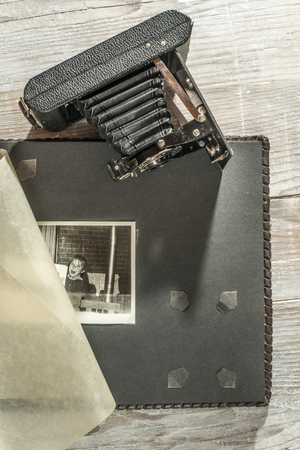 Vintage photo camera and album on white wooden backgroundの写真素材