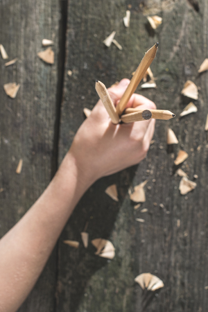 Vintage natural wooden pencils on dark wooden board
