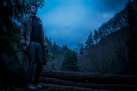 Young man in the forest at night. Early morningの写真素材