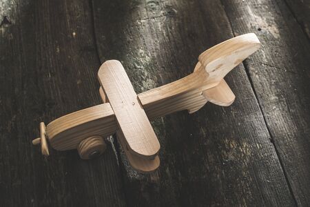 Vintage wooden plane on wooden board. Sunshine through the windowの写真素材