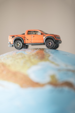 Offroad car on globe. Miniature concept