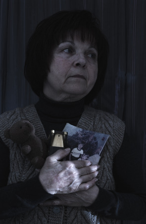 Senior woman hold pictures of childrens. Toysの写真素材