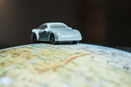 Car figure on globe. Miniature car toyの写真素材