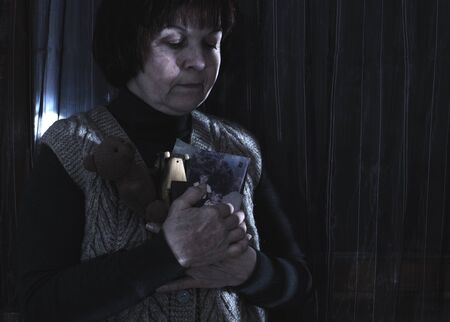 Senior woman hold pictures of childrens. Toysの写真素材