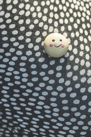 Smile icon on textile surface with white points.の写真素材