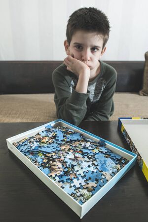 Child and puzzle. Pile puzzlesの写真素材