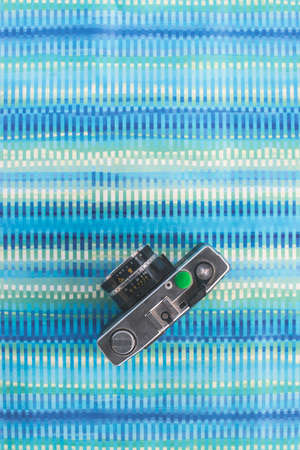 Vintage photocamera on blue paper background.の写真素材