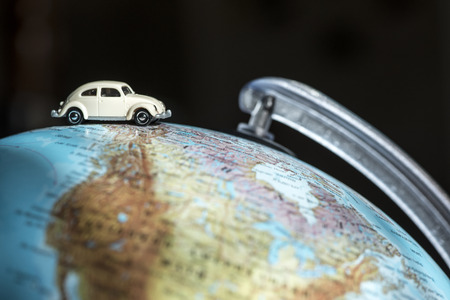 Car figure on globe. Miniature car toyの写真素材