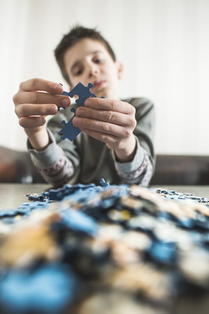 Child and puzzle. Pile puzzlesの写真素材