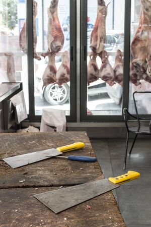 Veal and lamb meat in refrigerated display in a butcher shop.