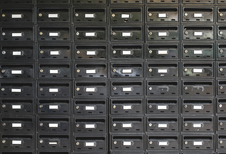 Many Black color mailboxes on wallの写真素材