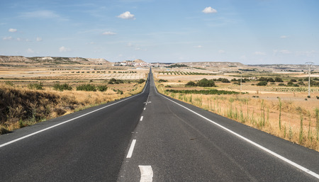 Long asphalt road and blue sky.