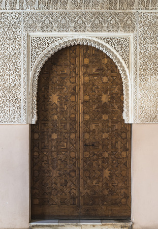 Islamic ornaments on wall. Arab symbols. Wooden doorの写真素材
