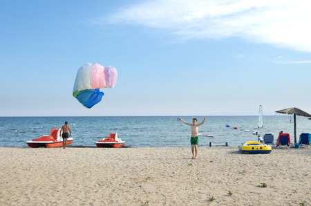 Child play with kite on the beachの写真素材