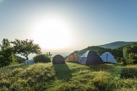 Many tents in the mountain. Outdoor concept. Sunshine morning in the forest.