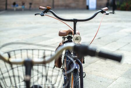 Black bike mounted on a bicycle stand on italian street.の写真素材