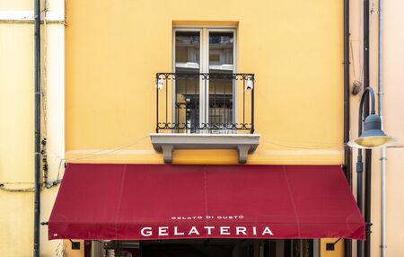 Italian ice cream shop. Text gelateria on sunshade. Italian architecture.の写真素材