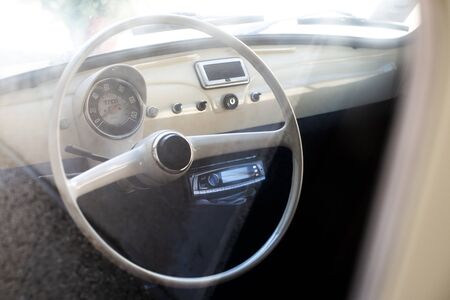 White interior of vintage car. White steering wheel.の写真素材