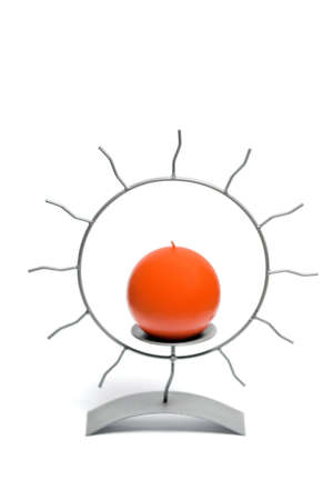 Orange candle in a metal candlestickの写真素材