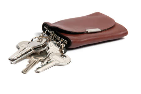 Keys in a brown leather case isolated against white background, horizontalの写真素材
