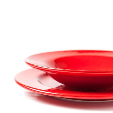 Colorful red ceramics plates on white background の写真素材