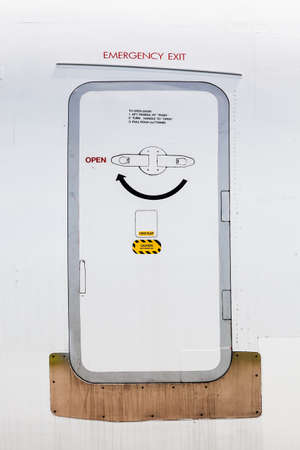 Emergency exit on an aircraft, view from outside of the planeの写真素材