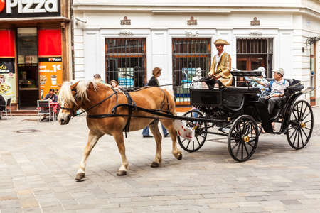 Tourists in a horse carriage in Old Town on May 9, 2013 in Bratislava, Slovakia. Bratislava is the most populous (462,000) and most visited city in Slovakia.のeditorial素材