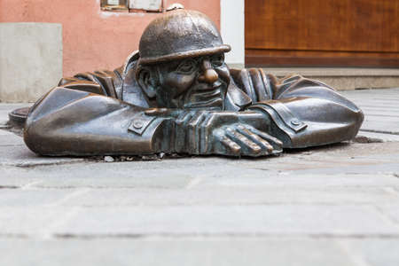 Cumil - statue of a man peeking out from under a manhole cover on May 9, 2013 in Bratislava, Slovakia. Popular tourist attraction was made in 1997 by sculptor Viktor Hulik.のeditorial素材