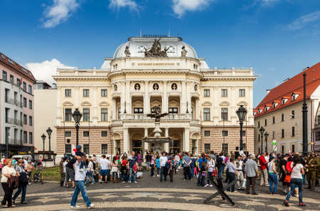 People in front of Slovak National Theater on Hviezdoslav Square in the Old Town on May 9, 2013 in Bratislava, Slovakia. It is the second oldest Slovak professional theatre.のeditorial素材
