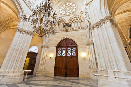 Entrance to the Cathedral in Burgos, Spain, which is under protection of UNESCO, with big doors, columns and a chandelierのeditorial素材