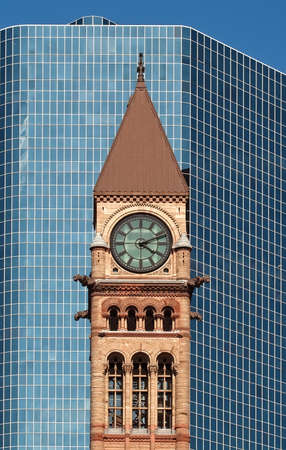  Old city hall of toronto in gothic style in front of a modern skyscraper under the sunset lightのeditorial素材