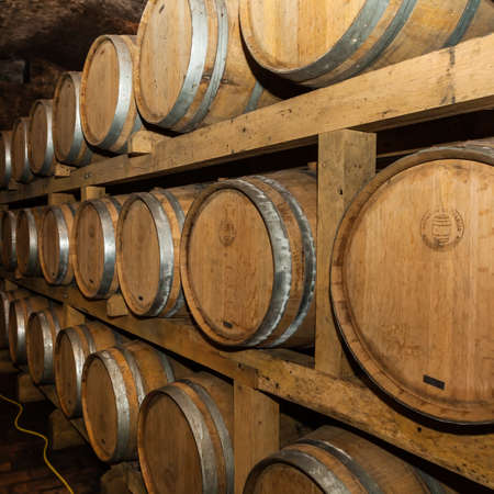 Old wine cellar in Ilok, Croatia, with old oak barrels on display; a must see tourist attraction in...