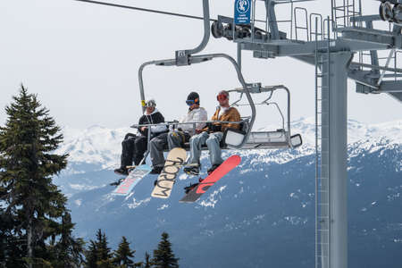 Skiers riding on ski lift in Whistler, Canada  Whistler is visited by over 2 million people each year for skiing in winter and mountain biking during summer のeditorial素材