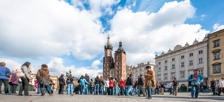 KRAKOW, POLAND - OCTOBER 3, 2009: People on the Main Market Square with St. Mary's Church in Krakow. At roughly 40.000 square meters it is the largest medieval town square in Europe.のeditorial素材