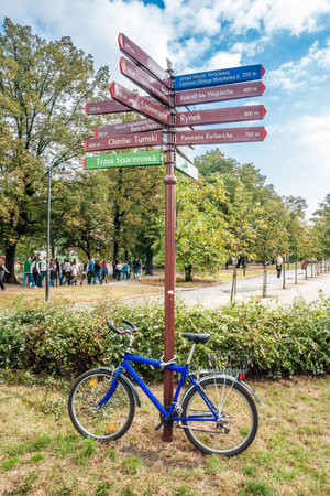 WROCLAW, POLAND - OCTOBER 7, 2009: Blue bike leaning against the traffic sign at Boulevard of Xavery Dunikowski in Wroclaw. Boulevard starts at Piaskowy bridge and goes along the Odra river.のeditorial素材
