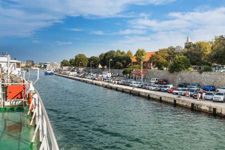 ZADAR, CROATIA - AUGUST 21, 2014: Jadrolinija car ferry arriving to Zadar old city port. Jadrolinija is state-owned with main mission in connecting Croatian islands to the mainland.のeditorial素材