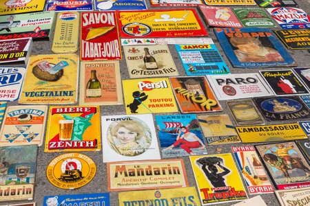 L'ISLE-SUR-LA-SORGUE, FRANCE - AUGUST 14, 2015: Old paper signs and covers on the street antique shop stand in L'Isle-sur-la-Sorgue flea market. Town is famous for its many antique shops and hosts antique markets most Sundays.のeditorial素材
